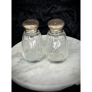 pair of vintage cut glass salt and pepper shakers with sterling silver tops